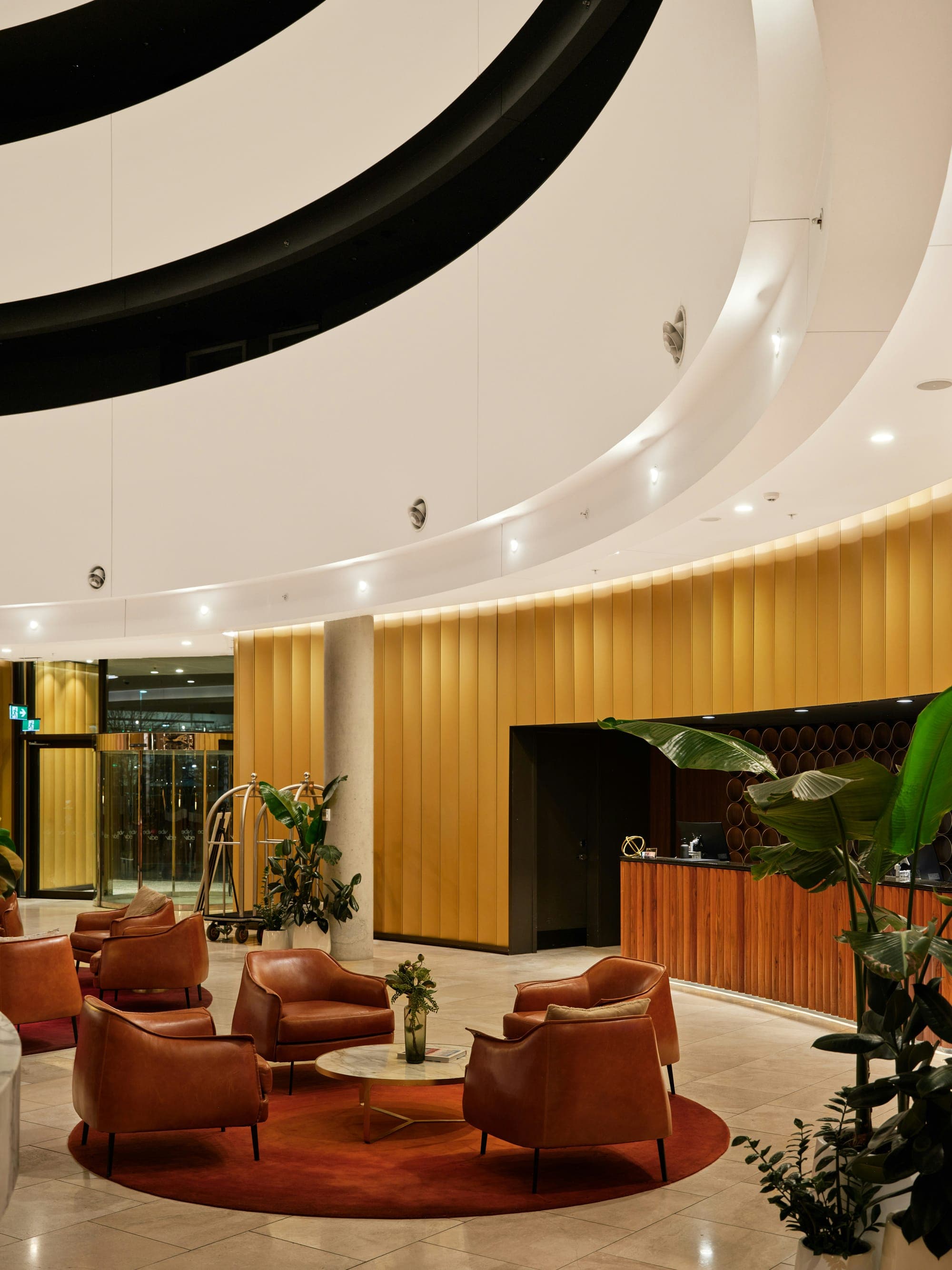 Modern business hotel lobby with leather seating area and reception desk